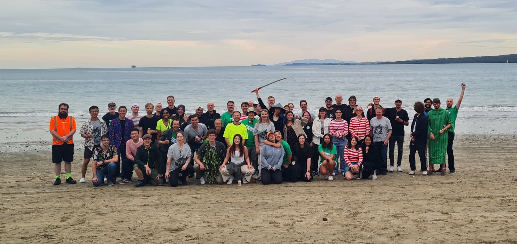 The Basis team gathered on a New Zealand beach at dusk