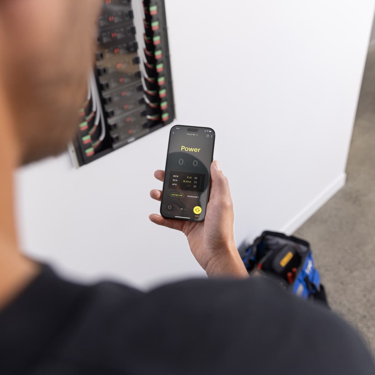 Electrician reviewing a Basis Board remotely via the Trade App